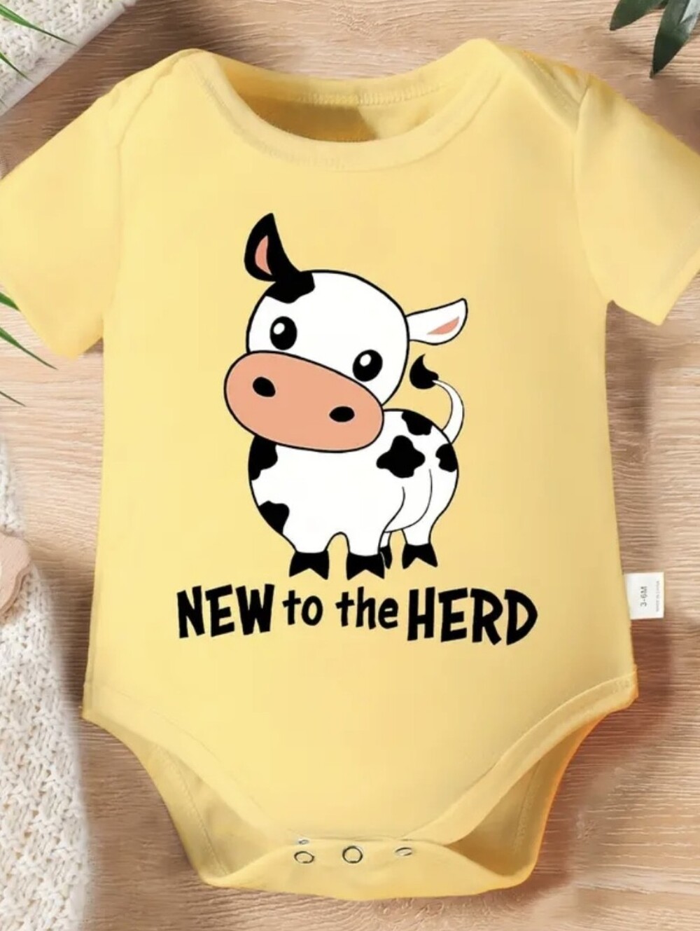 Yellow 'New to the Herd' Cow Print Baby One-Piece